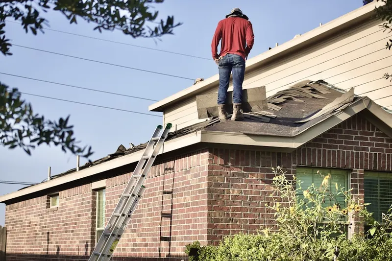 Professional roofer working on a residential roof in Bend
